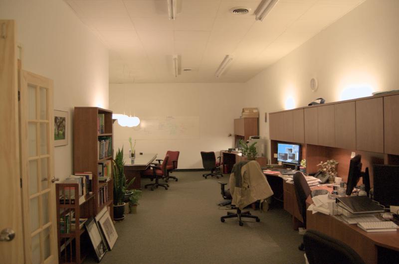 office with clutter, pictures, furniture and nice lighting