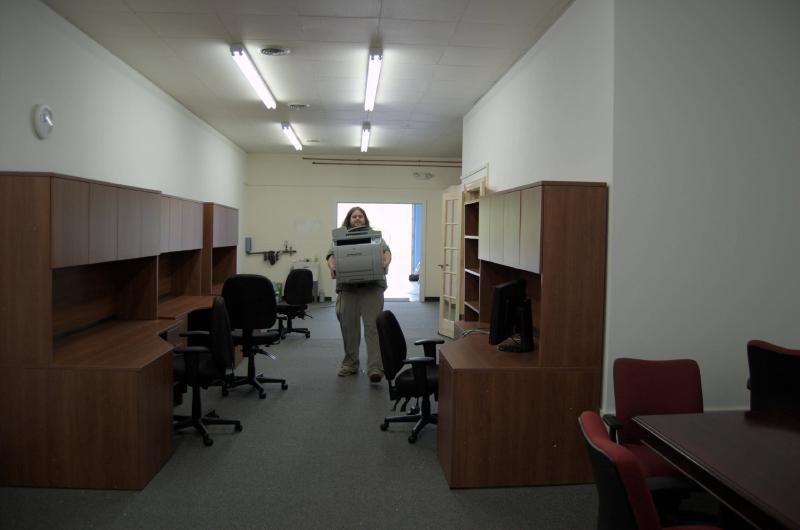 nick carrying printer afer new desks were delivered