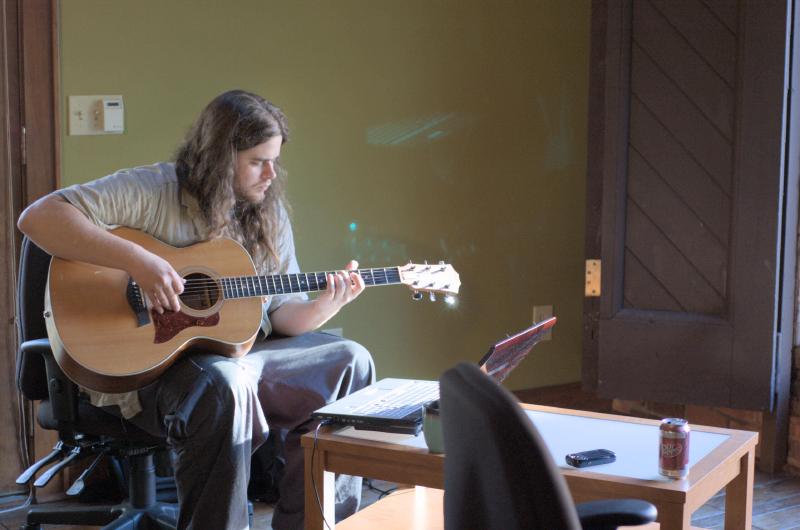 nick playing guitar in willett house