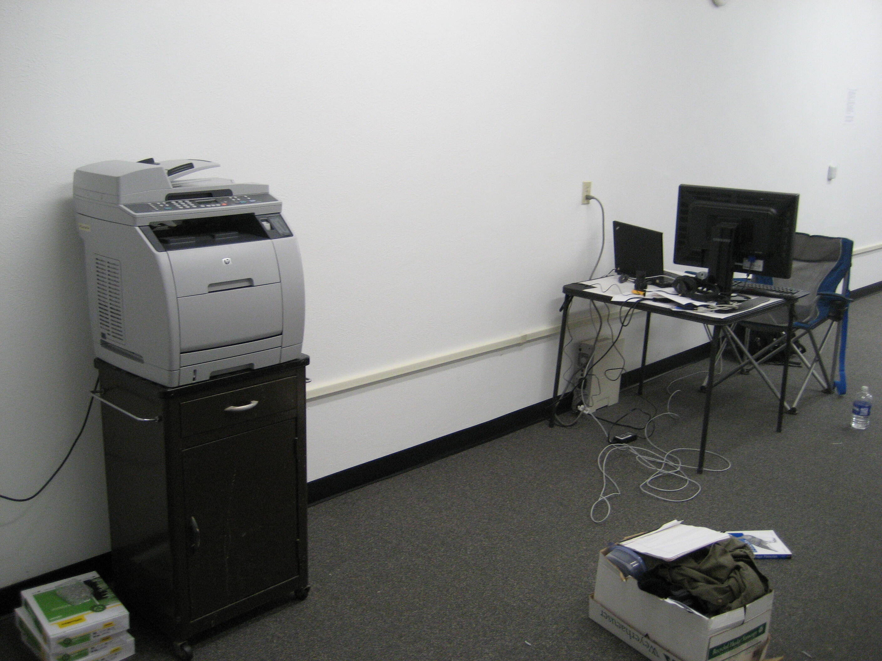 kevin’s desk at drywall lane office next to lonely printer